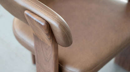 Duke Dining Armchair in Vintage Mocca leather with walnut frame — armrest stitching detail close-up