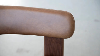 Duke Dining Armchair in Vintage Mocca leather with walnut frame — backrest stitching detail close-up