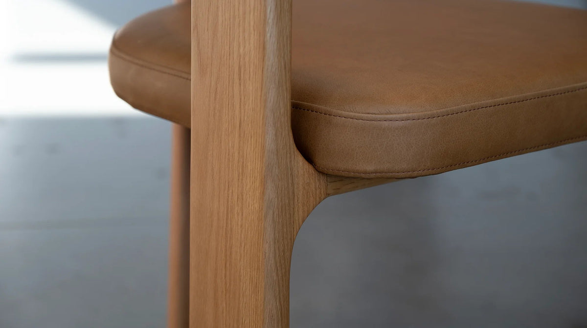 Duke Dining Armchair in Vintage Tan leather with natural oak frame — seat and leg detail close-up