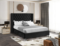 Aiden Black Velvet Upholstered Bed in a styled bedroom