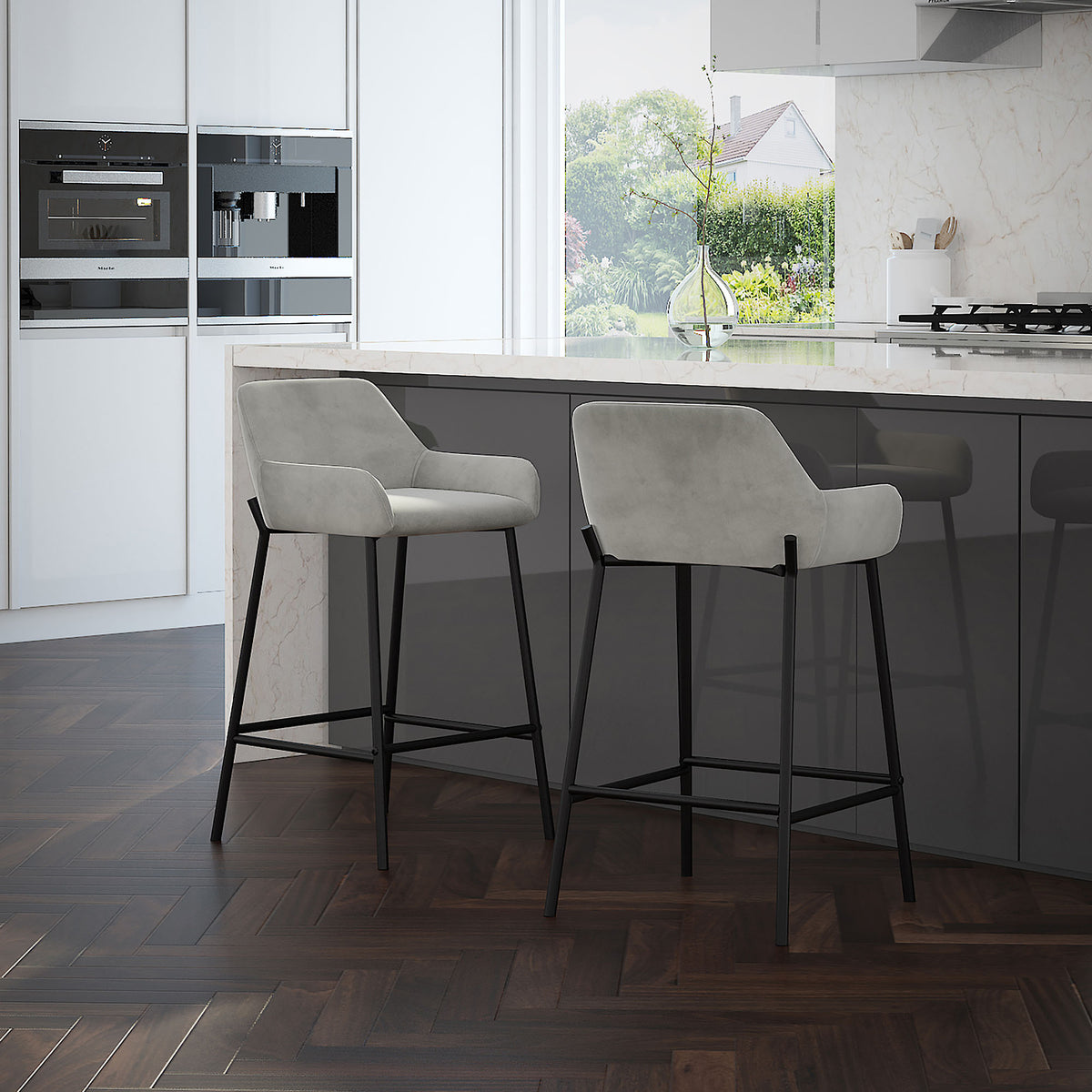 Two Baily 26 inch counter stools in grey velvet at a modern kitchen island with a marble countertop