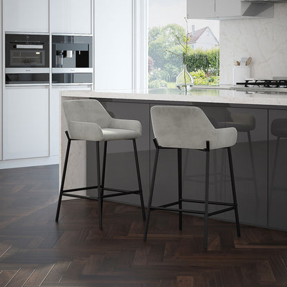 Two Baily 26 inch counter stools in grey velvet at a modern kitchen island with a marble countertop