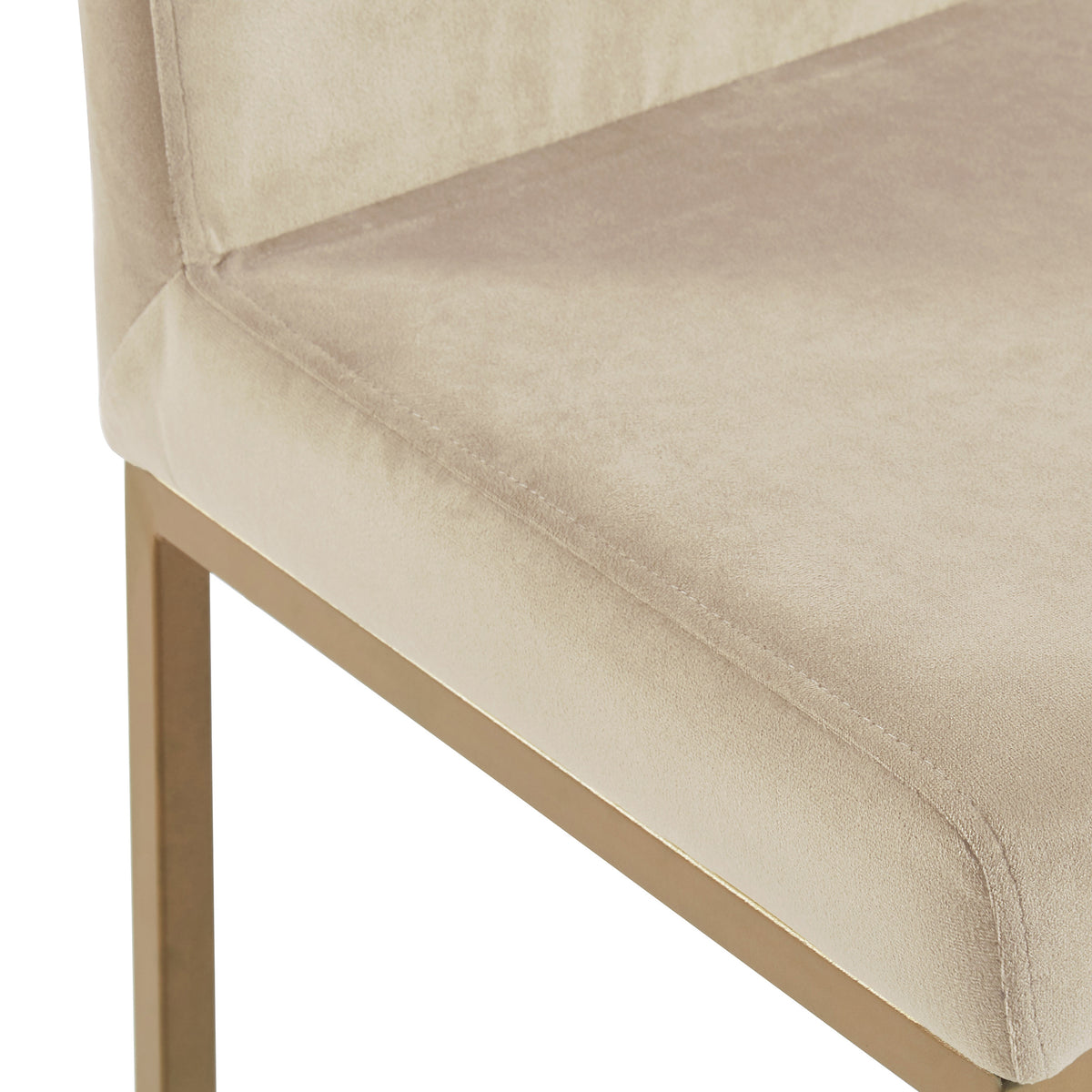 Close-up of the Diego counter stool's beige velvet seat and aged gold leg detail