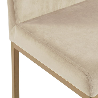 Close-up of the Diego counter stool's beige velvet seat and aged gold leg detail
