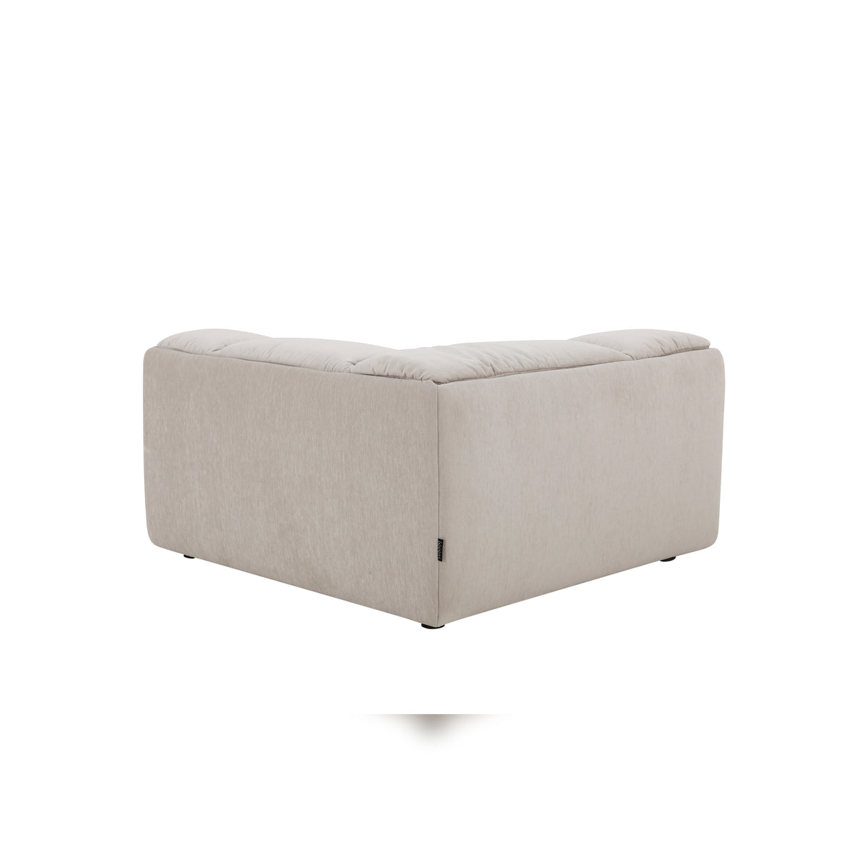 Modani Modular Sectional in beige, rear view of the matching upholstered ottoman showing its plain back and side panels on a white background