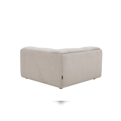 Modani Modular Sectional in beige, rear view of the matching upholstered ottoman showing its plain back and side panels on a white background